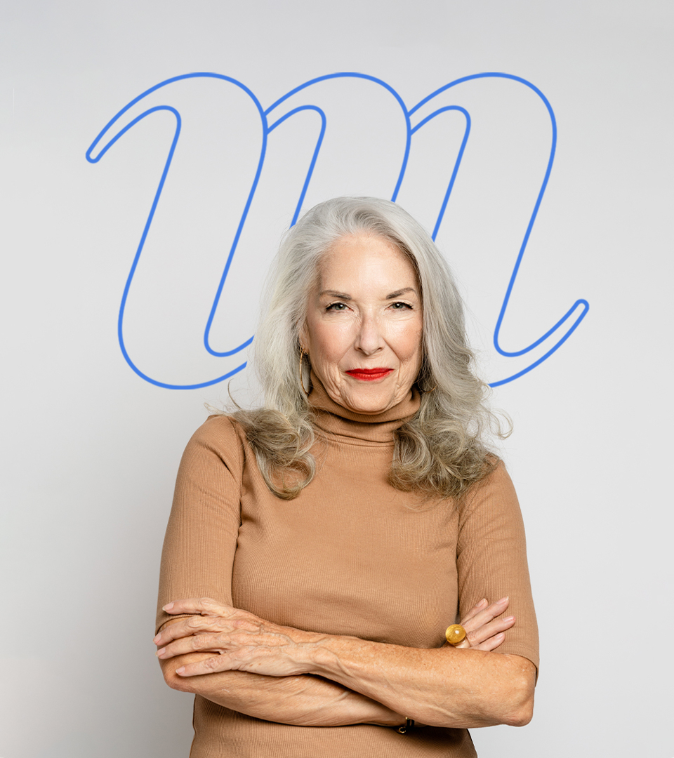 s﻿tudio portrait of woman with The Mom Project monogram behind her head